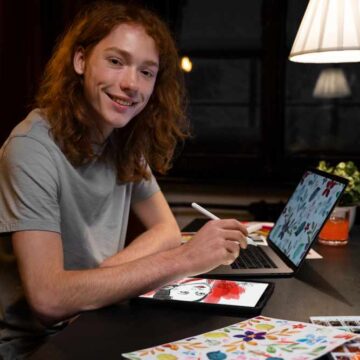 creator working on tablet and laptop